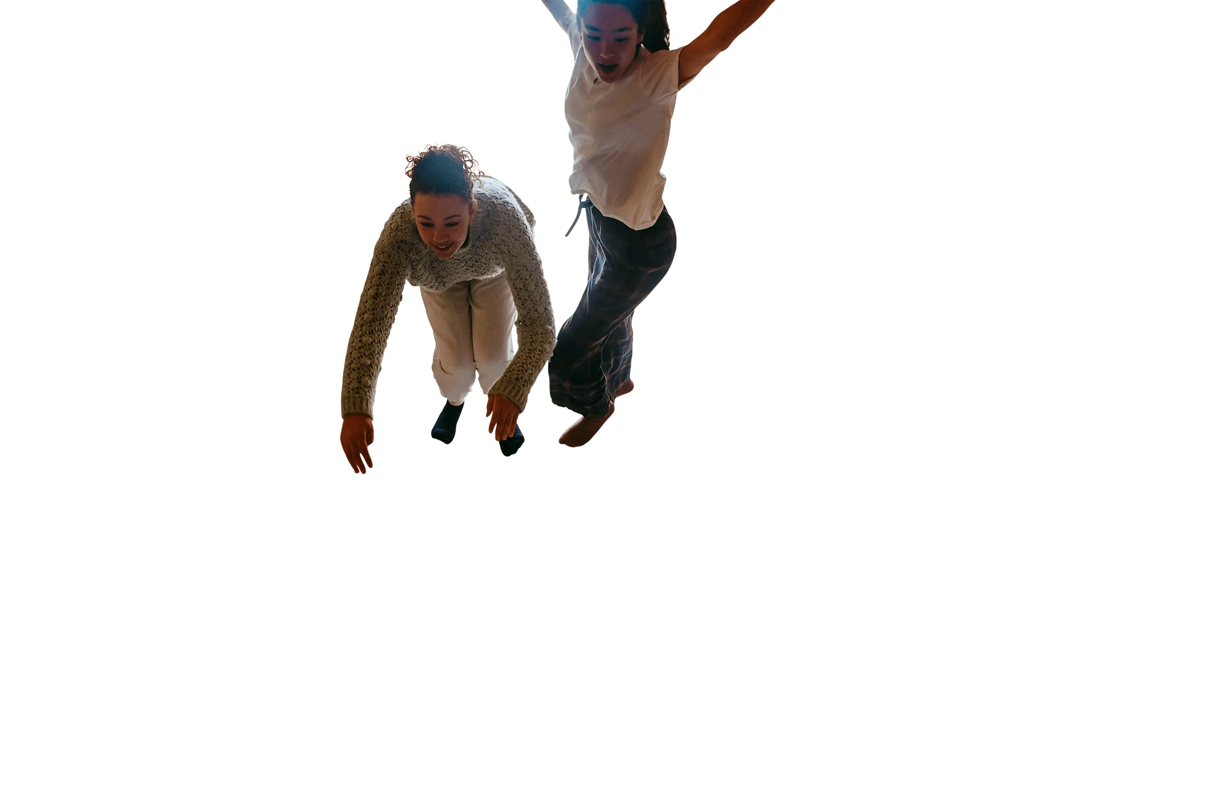 Girls jumping on bed